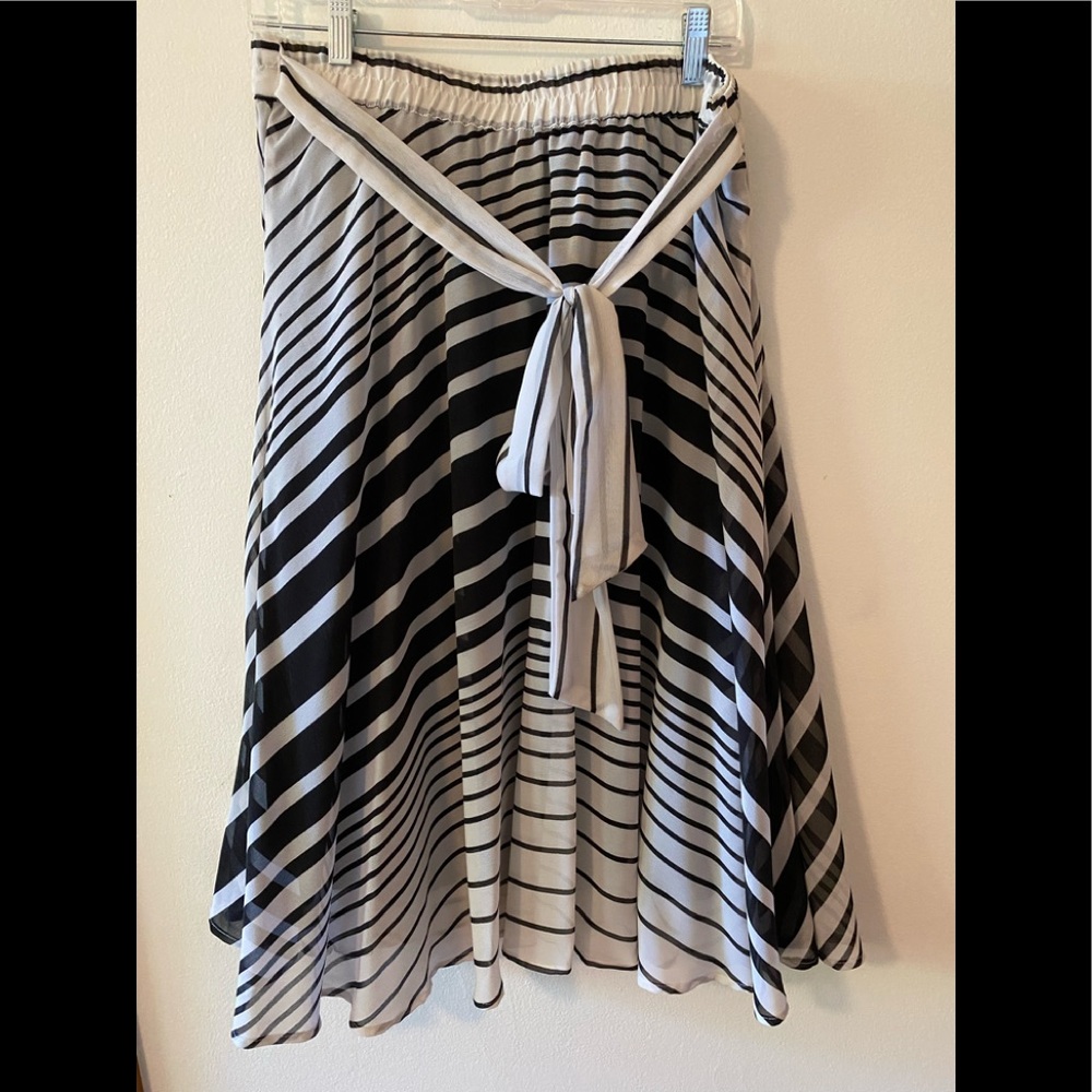 Long lined in black off white and black striped skirt with bow.